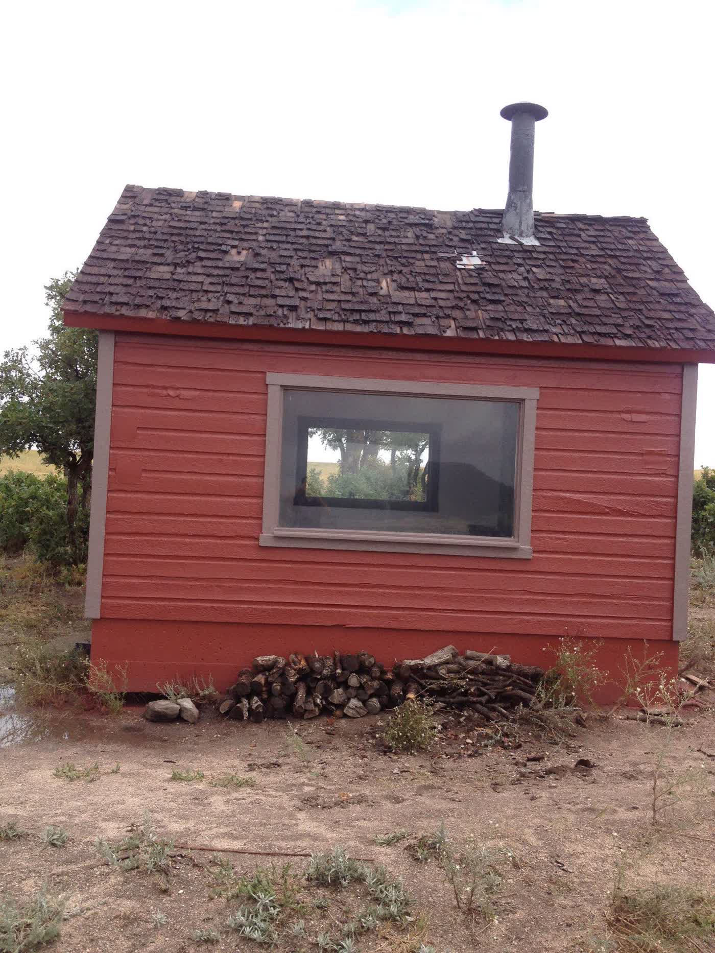 Compact red outbuilding freshly coated